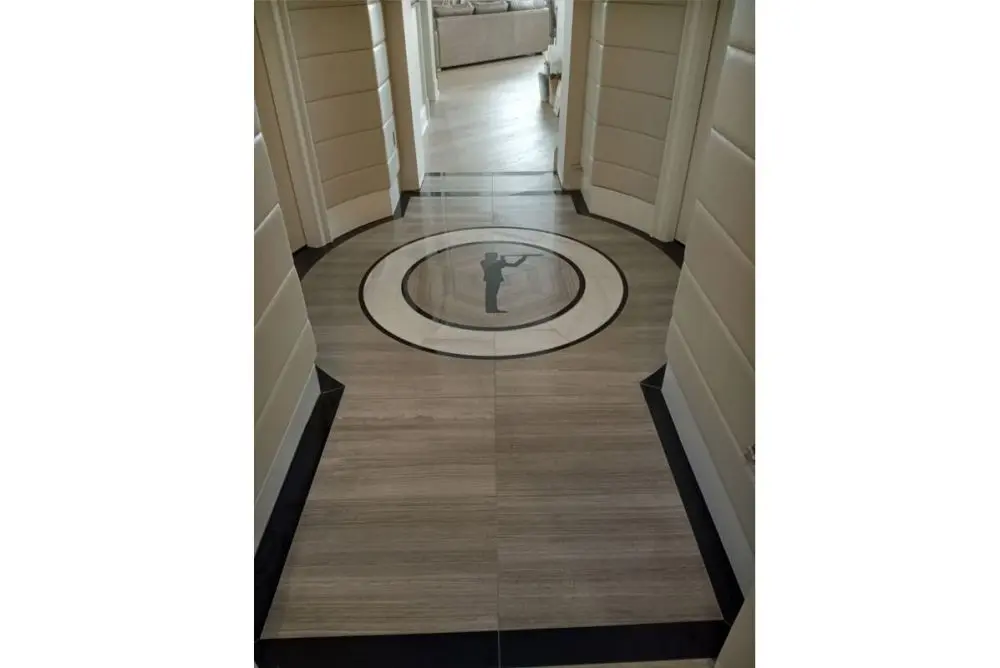 Intricate custom floor inlay design by Homestead Woodworks, featuring a central decorative pattern